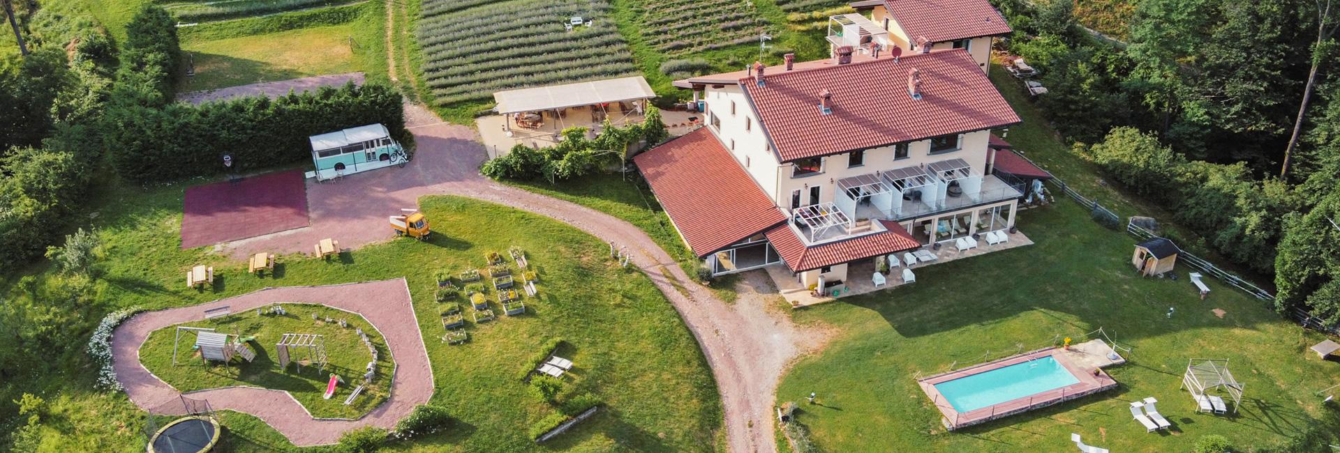 Aerial view of a villa with pool and lush garden.