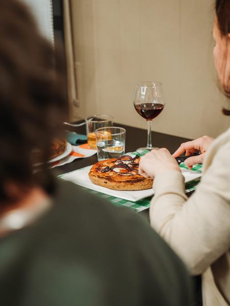 Cozy dinner with pizza, red wine, and warm conversations.