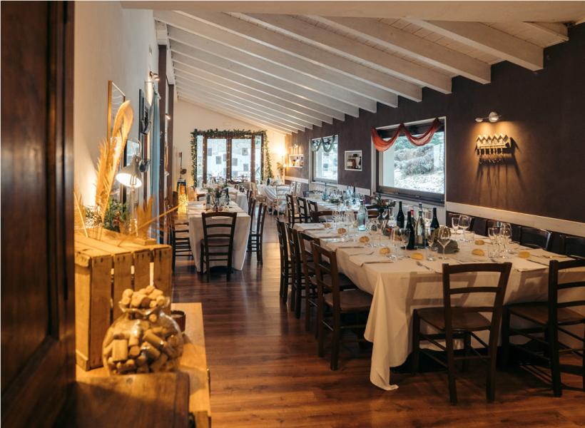 Cozy restaurant with elegant tables, warm atmosphere, and festive decorations.