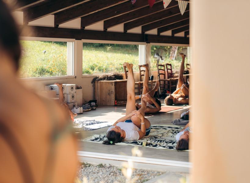 People practicing yoga in a bright veranda, relaxed and serene.