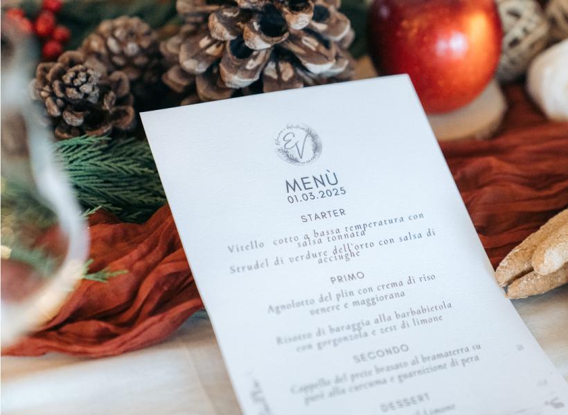 Elegant and festive menu with natural details, pine cones, and crusty bread.