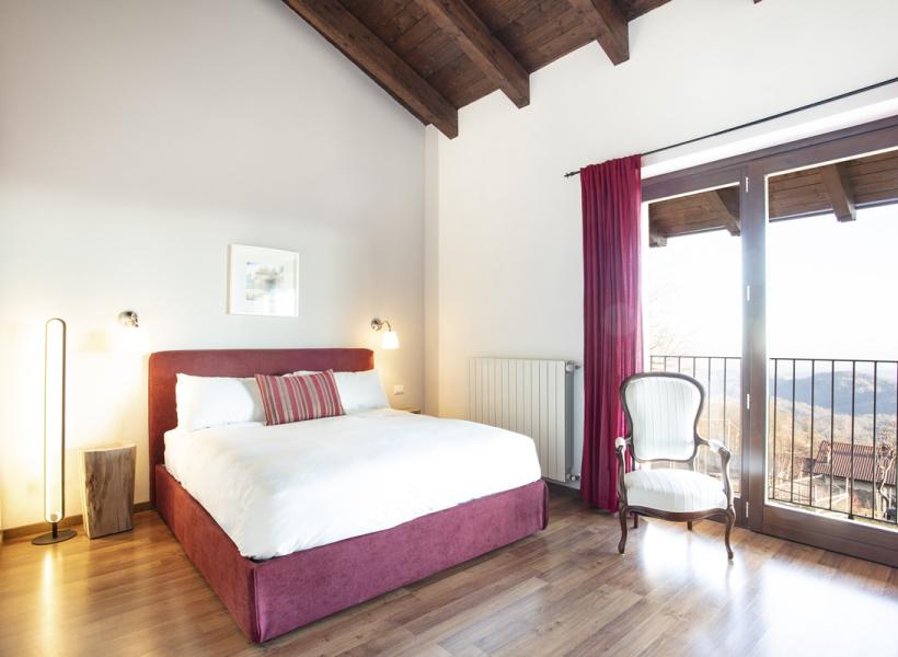Bright room with cozy bed and panoramic view.